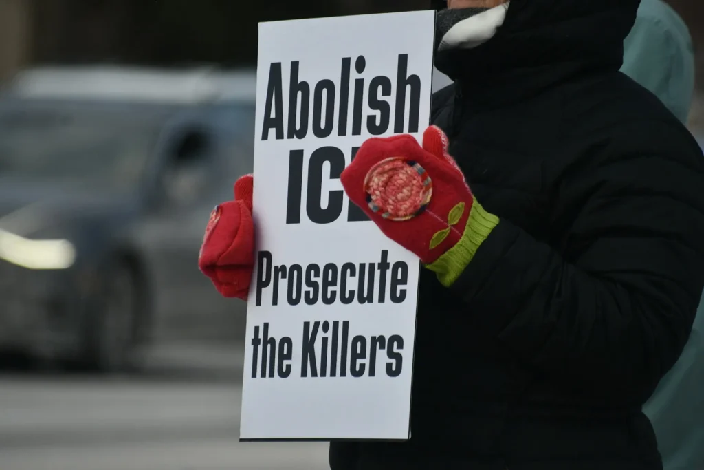 Protester with an abolish ice sign